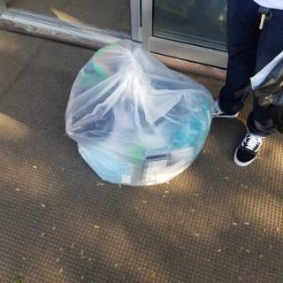 A garbage bag filled with items, waiting to be disposed of properly.