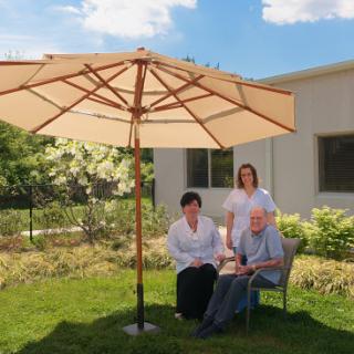 A serene moment in the garden under a large umbrella.