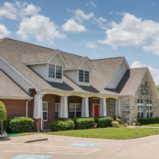 A suburban house with a brick exterior and well-maintained landscaping.