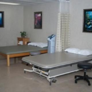 A therapy room with treatment tables in a medical facility.