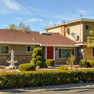 A suburban house with well-maintained landscaping and a two-story structure.