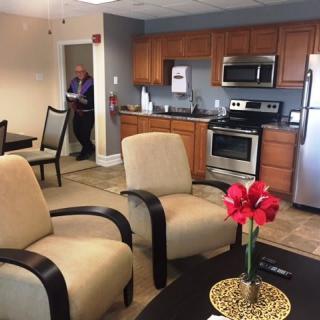A modern living space with a cozy kitchen and seating area.