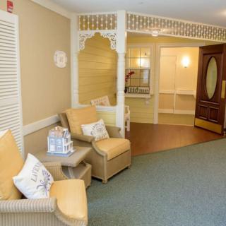 A cozy seating area in a lobby with comfortable chairs and decorative elements.