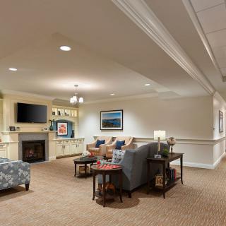 A cozy living room with comfortable seating, a fireplace, and decorative elements.