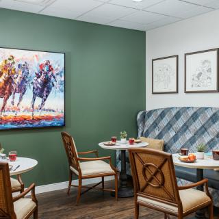 A cozy cafe interior with elegant seating, decorated walls, and artwork.