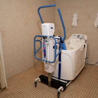 A patient lift system designed for accessibility in a bathroom setting.