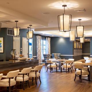 A stylish and modern restaurant interior featuring elegant lighting and comfortable seating.