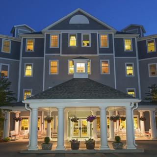 A brightly lit hotel entrance at night with a welcoming facade.