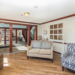 A cozy living room with stylish furniture and wood flooring.