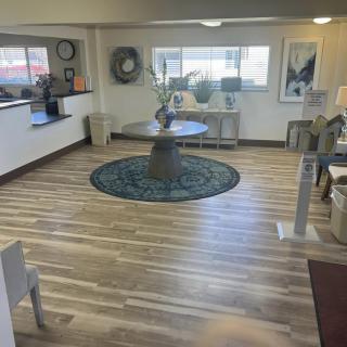 A modern lobby area featuring a round table and decorative elements.