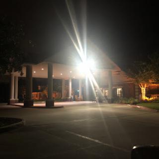 A well-lit entrance of a building at night.
