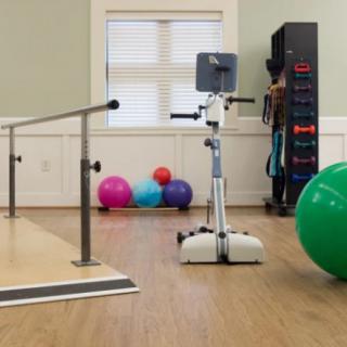 A physical therapy room equipped with various rehabilitation and exercise tools.