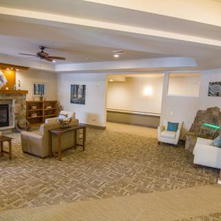 A cozy living room with a fireplace and comfortable seating arrangements.