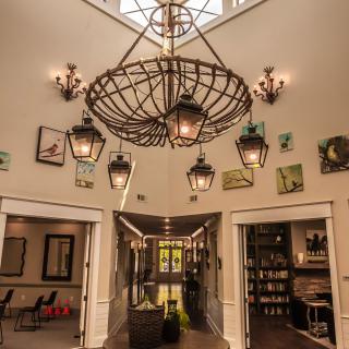 Elegant lobby with a large chandelier and wall artwork.
