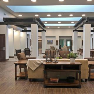 A spacious and modern lobby featuring elegant furniture and ample natural light.