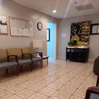A quiet waiting room with chairs and wall decorations.