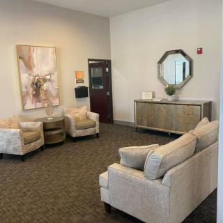 A modern waiting room with comfortable seating and elegant decor.