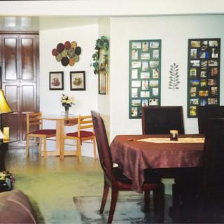 A cozy dining area with a set table and wall decor.