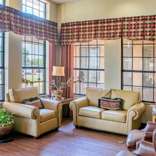 A cozy living room with two sofas and large windows.