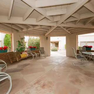 A cozy outdoor patio featuring comfortable seating and beautiful landscaping, perfect for relaxation.