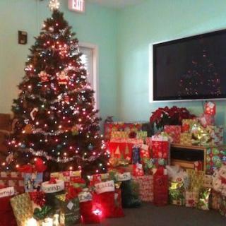 A beautifully decorated Christmas tree surrounded by an array of colorful gifts.