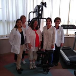 Healthcare professionals gathered in a fitness area, showcasing their commitment to wellness and rehabilitation.