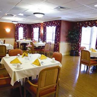 An elegantly arranged dining room with tables set for a meal.