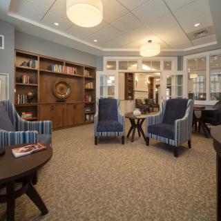 A cozy living room with comfortable seating and bookshelves.