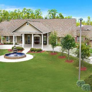 A beautiful house with a well-maintained garden and fountain.