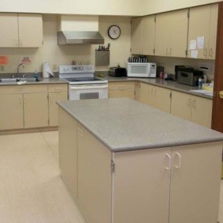 A spacious kitchen with beige cabinets and a central island.
