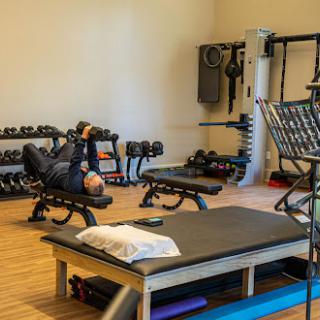A workout session in a well-equipped gym featuring various exercise equipment.