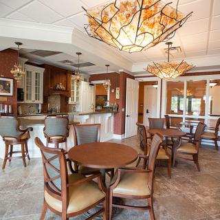 A cozy dining space with elegant wooden furniture and decorative chandeliers.
