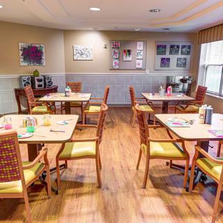 A cozy dining area with neatly arranged tables and chairs.