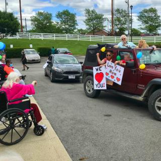A joyful community parade filled with love and support, featuring colorful signs, balloons, and happy participants.