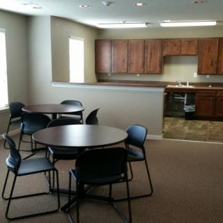 A modern kitchen and dining area with tables and chairs.