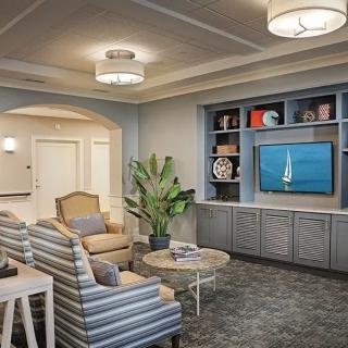 A modern living room with comfortable seating and a large TV.