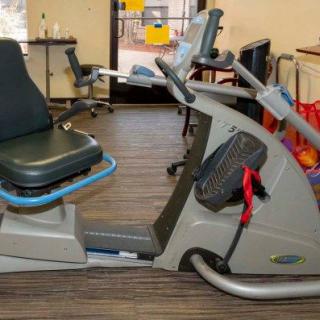 A recumbent exercise bike in a gym setting.