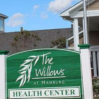 Sign for The Willows at Hamburg Health Center in front of a building.