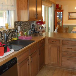 A tidy kitchen with wooden cabinets and a variety of appliances.