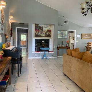 A spacious and inviting living room featuring a contemporary design with modern furniture and decorative elements.