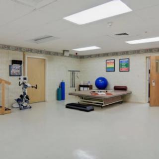 A physical therapy room equipped with various rehabilitation tools and exercise equipment.