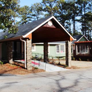 A charming residential house featuring a stone faade and inviting porch.