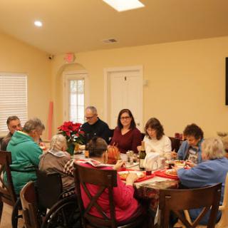 A warm gathering of individuals enjoying a meal together.