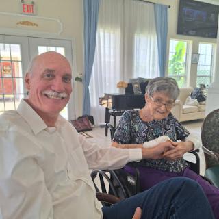 A joyful moment shared between two friends in a cozy indoor setting.