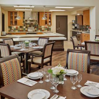 A beautifully arranged dining area with a modern kitchen in the background.