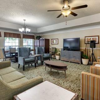 A spacious living room with comfortable seating, a large television, and elegant decor.