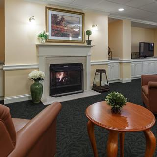 A cozy lounge area featuring a fireplace and comfortable seating.