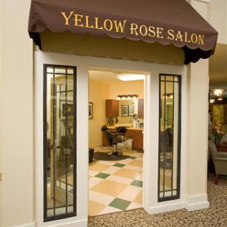 The entrance of Yellow Rose Salon, exhibiting a welcoming interior and stylish design.