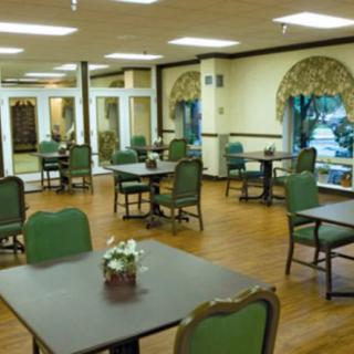 An empty dining room with neatly arranged tables and chairs.