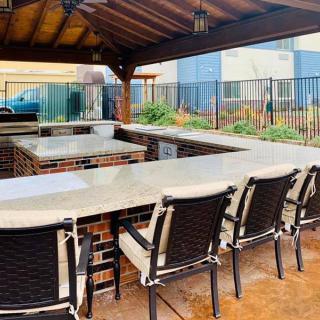 An outdoor patio bar area with a covered roof and seating.